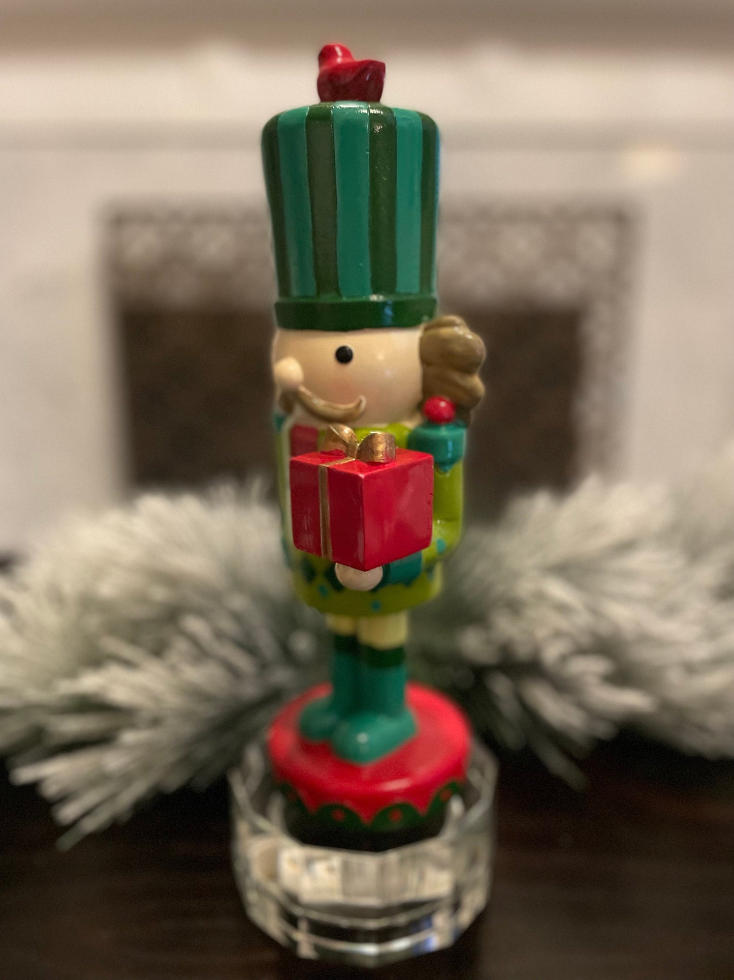Nutcracker. 12” resin nutcracker with packages. Multi color.