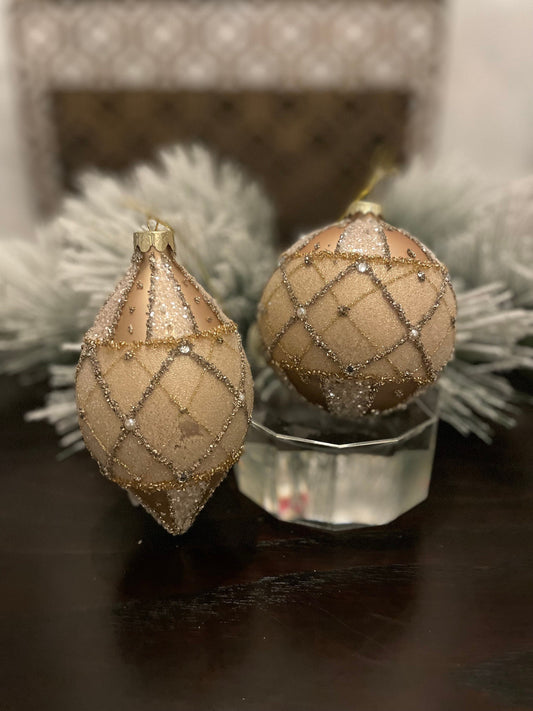 Set of 2. 4-6” glass jewel edge ball and finial ornaments. Ivory and gold.