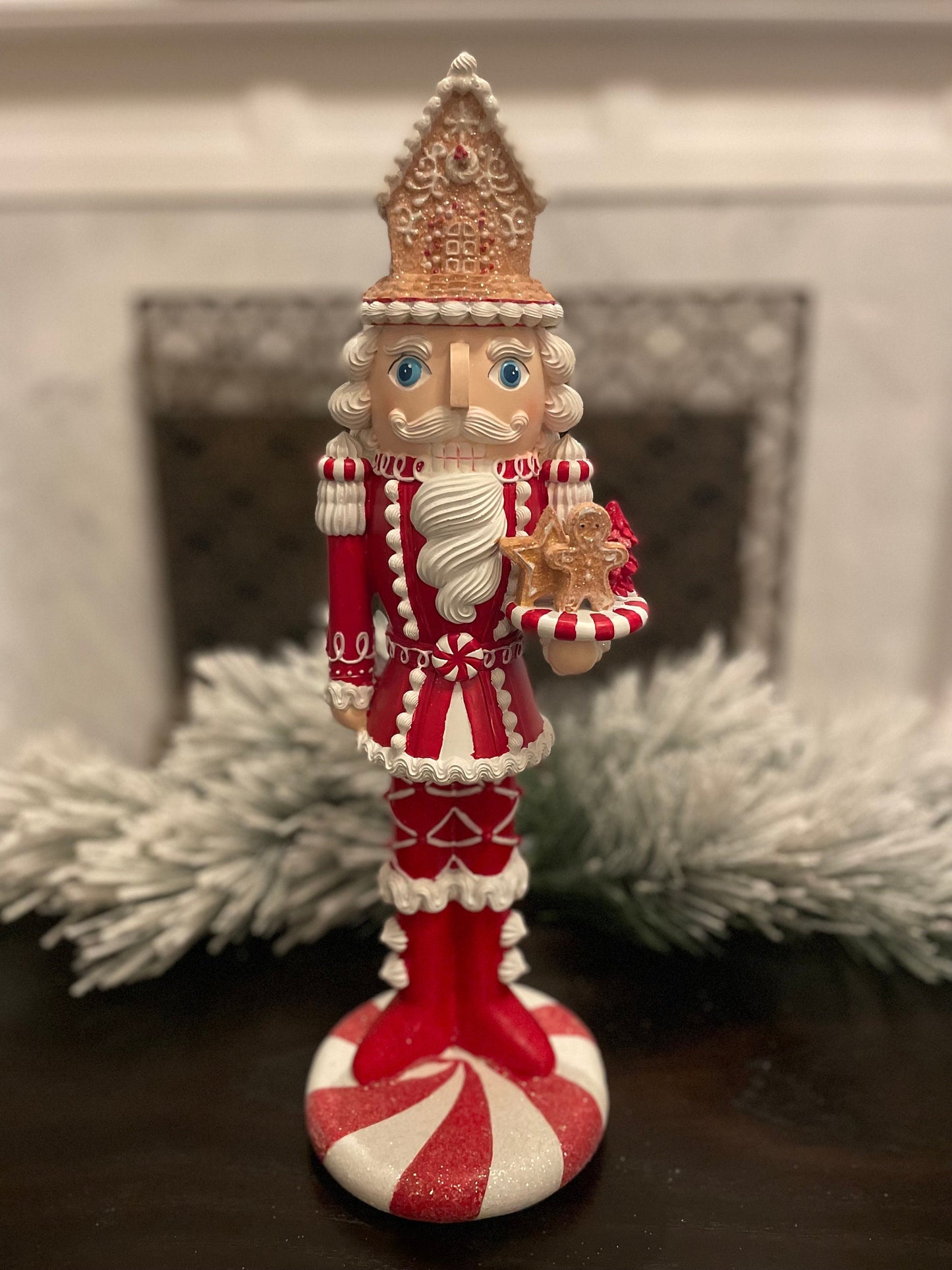 17.5” Nutcracker with gingerbread house, resin peppermint red and white. Sweet nutcracker!