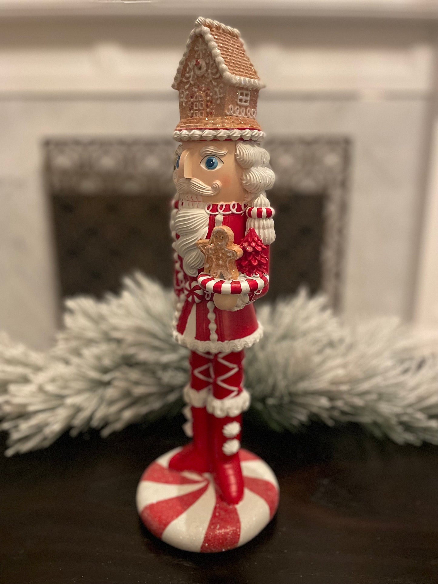 17.5” Nutcracker with gingerbread house, resin peppermint red and white. Sweet nutcracker!