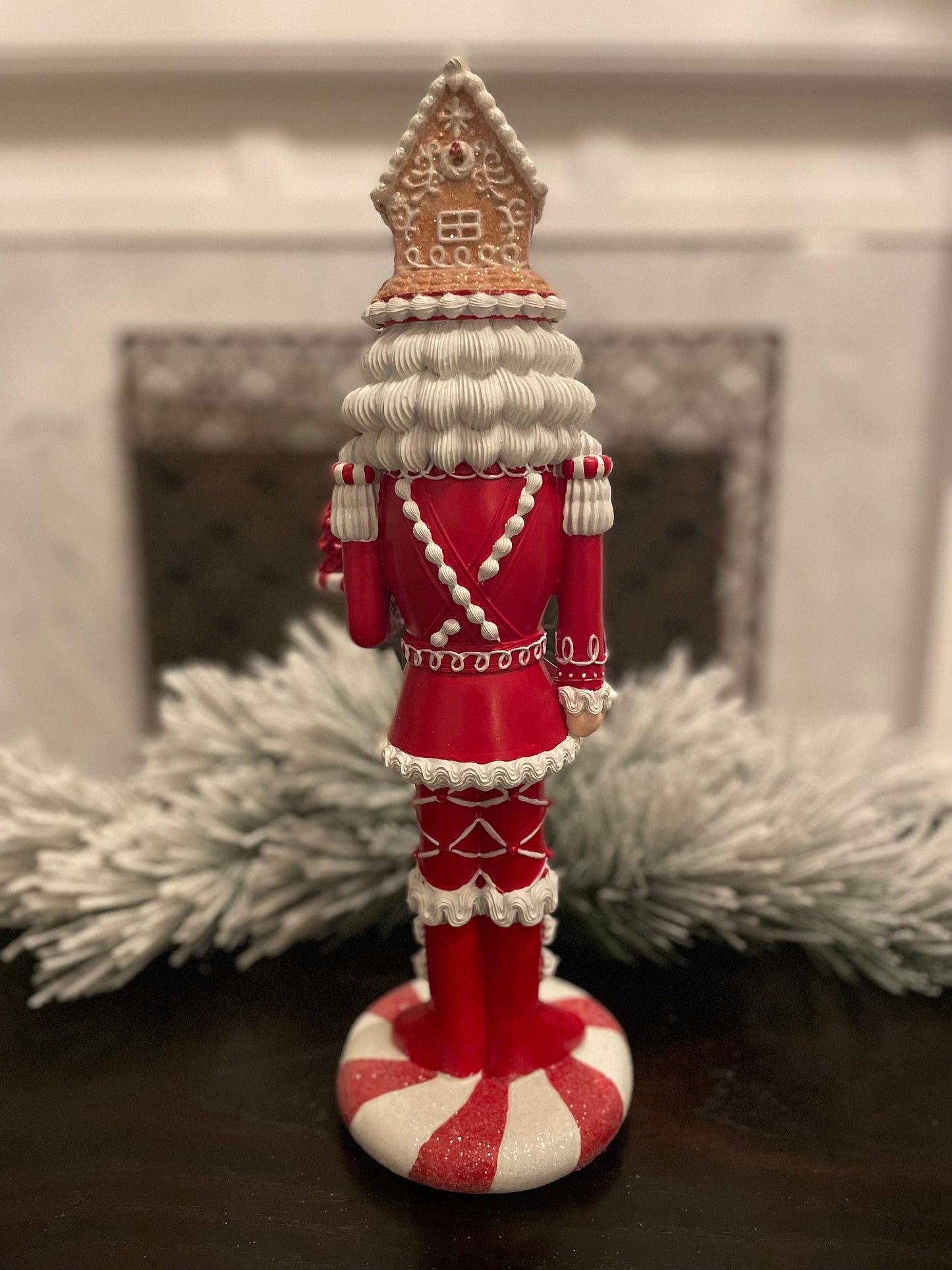 17.5” Nutcracker with gingerbread house, resin peppermint red and white. Sweet nutcracker!