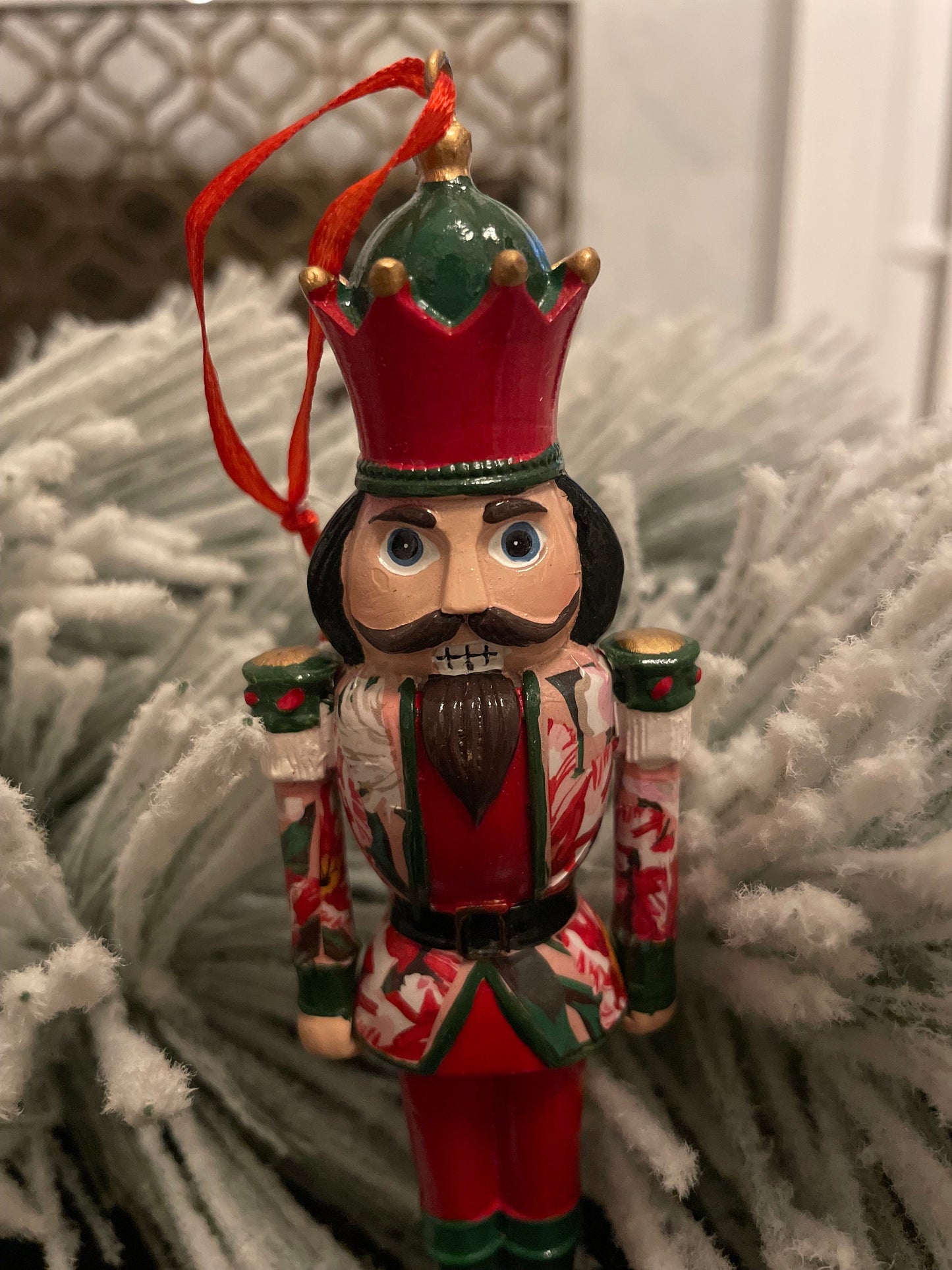 6” Poinsettia nutcracker ornament. Resin.