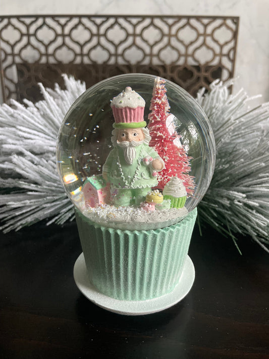 6" Cupcake and nutcracker water music globe. Pastel colors. Candy. Music jingle bells.