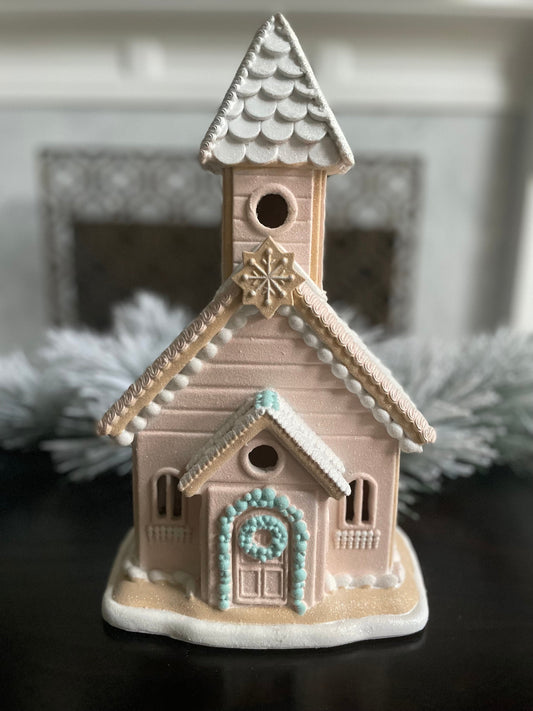 14”H x 8”W x 6” D. Gingerbread lighted church. Pink and blue.