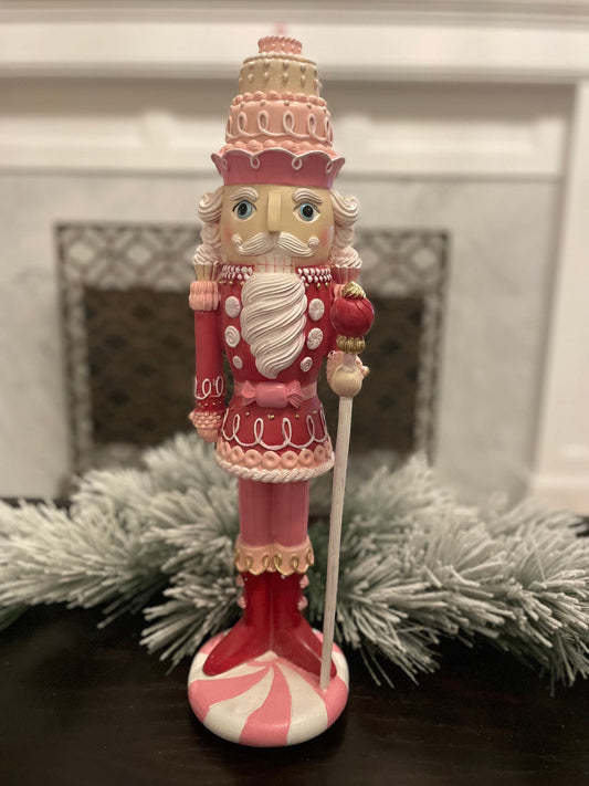 18.75” Nutcracker with cake resin pink peppermint. Sweet nutcracker!