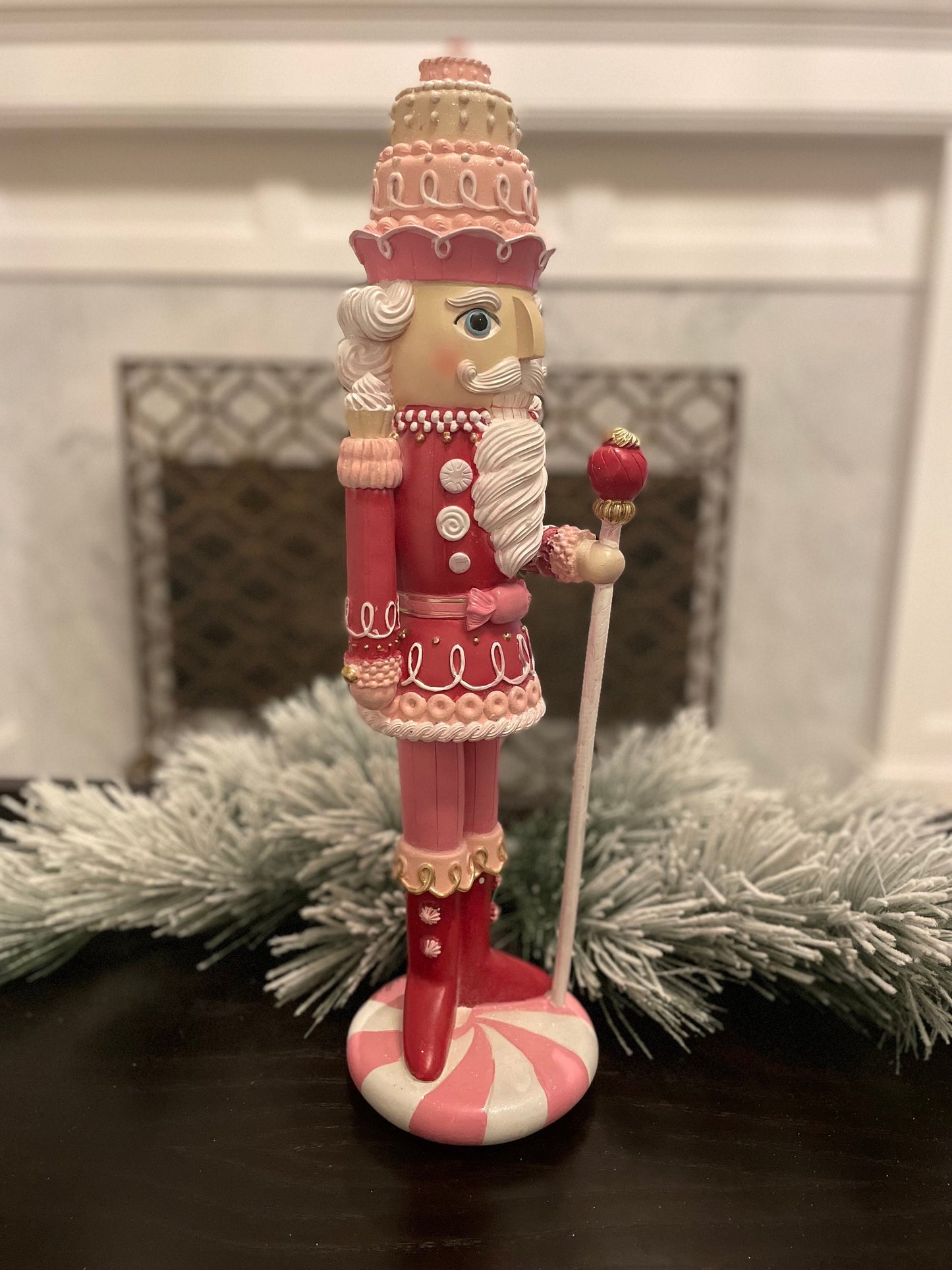 18.75” Nutcracker with cake resin pink peppermint. Sweet nutcracker!