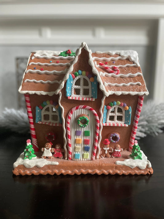 12"H x 13” W x 9” D. Lighted gingerbread house. Multicolor.